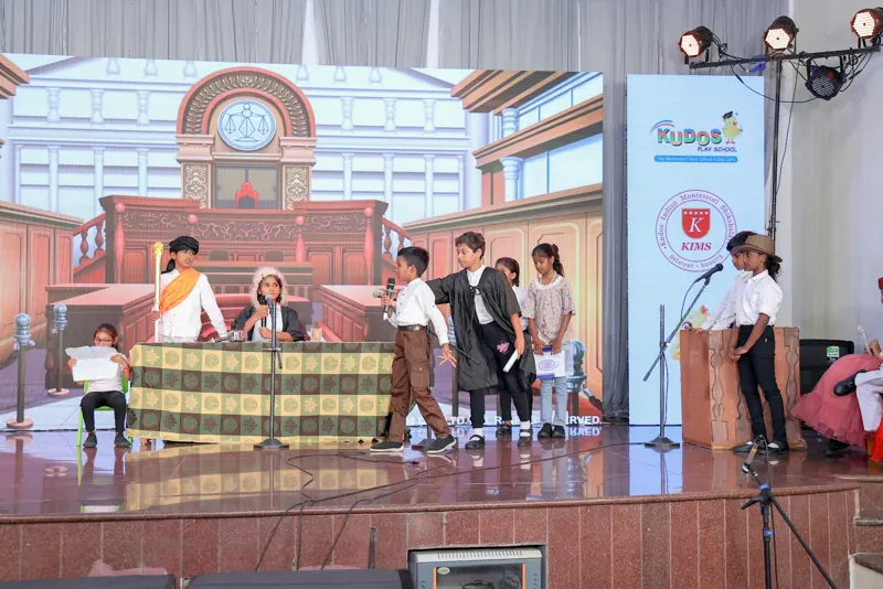A courtroom play with a judge's bench and lawyers
