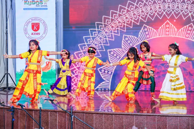 A classical dance in bright yellow, red and pink