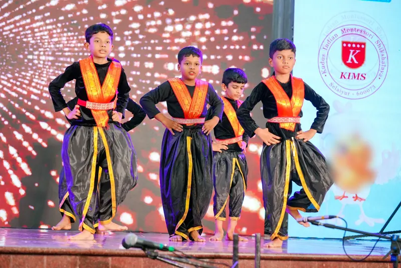 Boys in black and orange costumes strike a pose