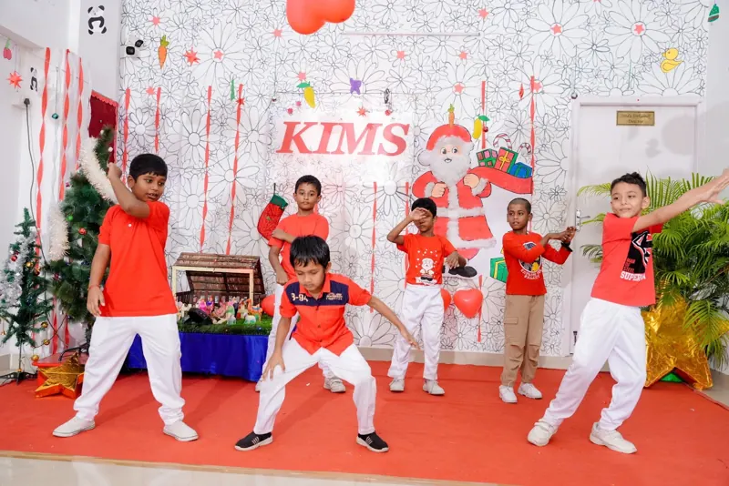 Children strike a pose in front of the Christmas set
