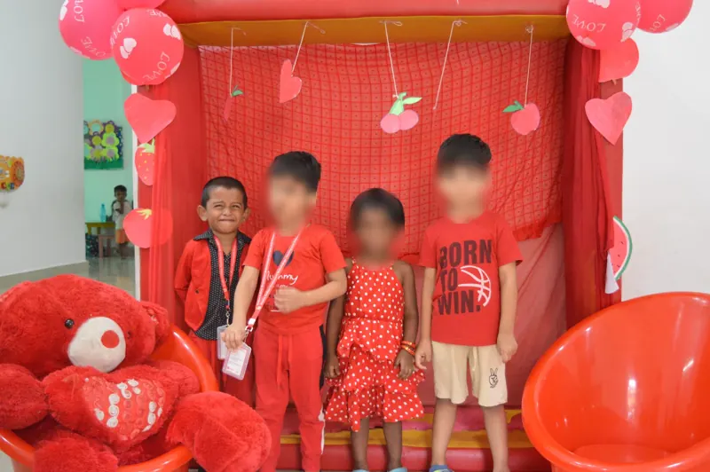 A group in red with a big teddy bear