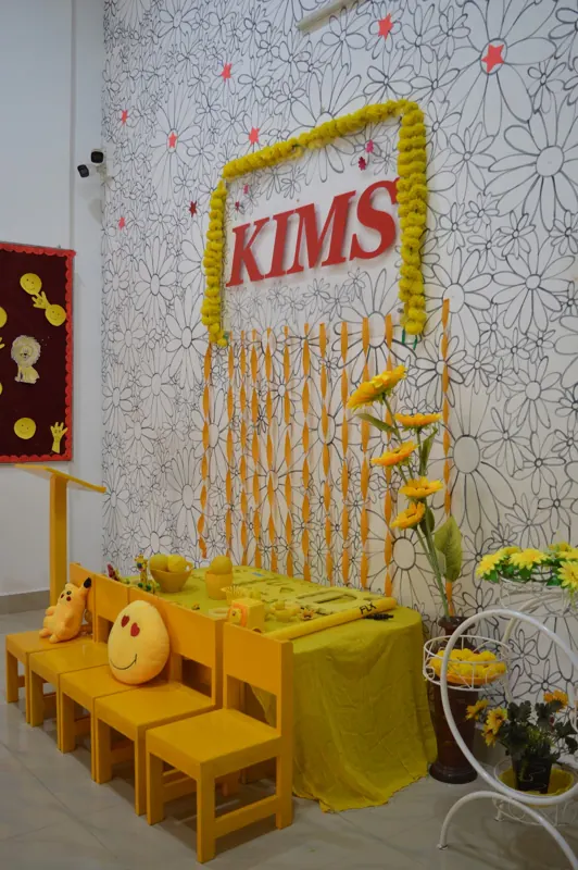 The yellow corner with small chairs and sunflowers
