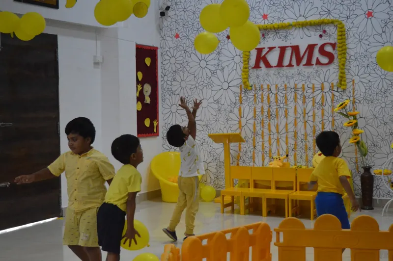 Children jump for yellow balloons