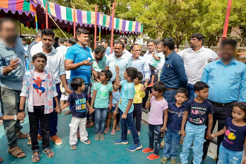 Fathers and children gather under the canopy