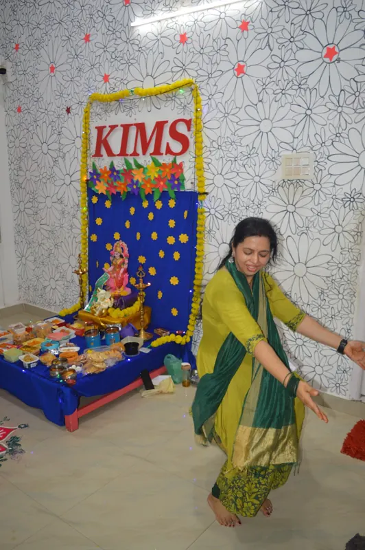 A teacher dances by the festival altar
