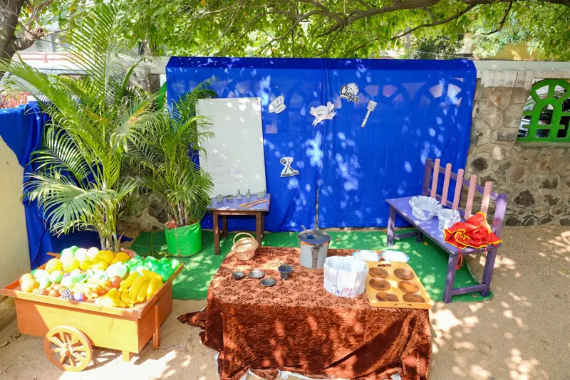 The play kitchen set with a vegetable cart
