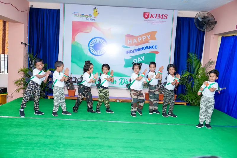 Children in camouflage perform a soldiers' dance