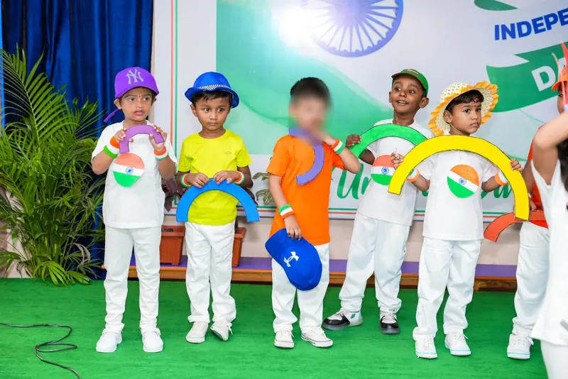 Children hold up rainbows in tricolour