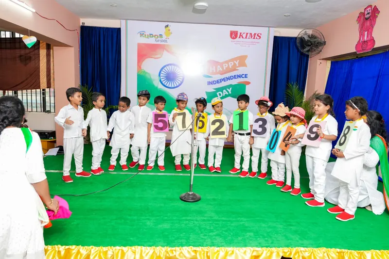 Children in white perform an action song