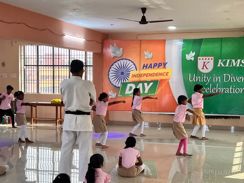 Children practise karate moves with their instructor