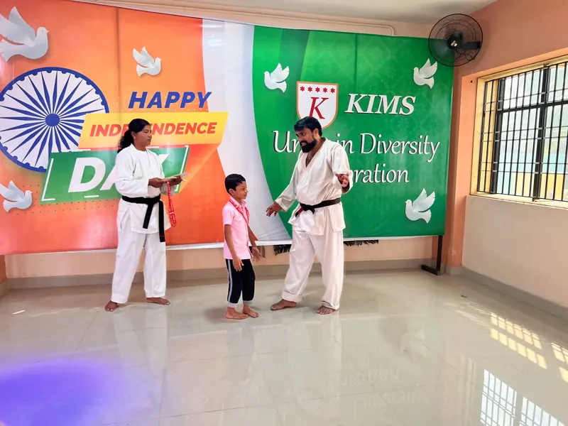 A child receives a certificate and belt from the instructor
