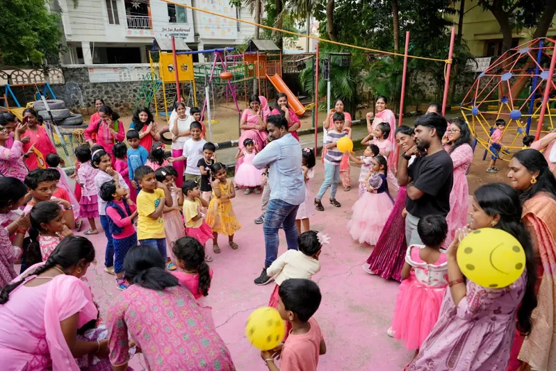 Mothers and children play a ball game