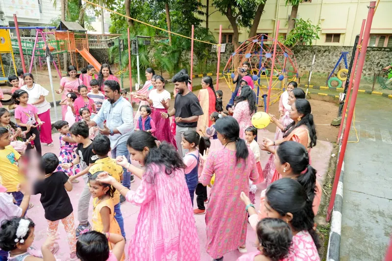 Mothers and children dance in the playground