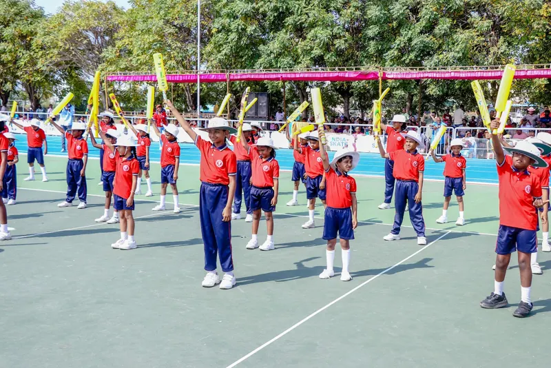 Older children perform a drill with yellow batons