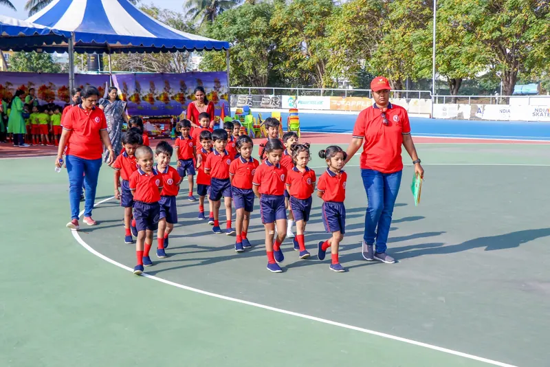A class walks out onto the track with their teachers