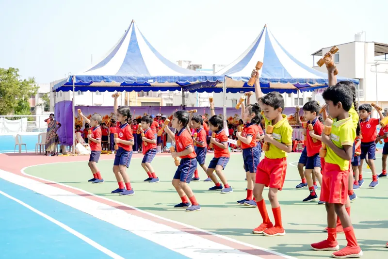 Children perform a dance drill near the canopy