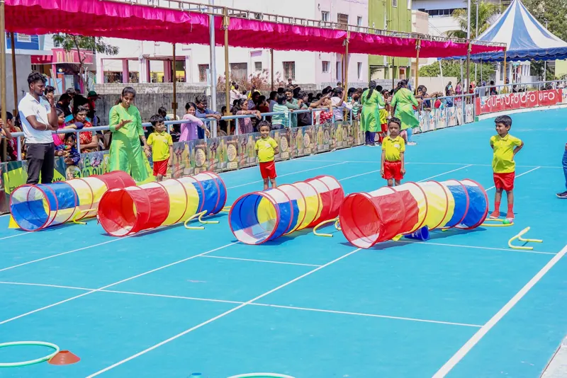 The youngest children crawl through coloured tunnels
