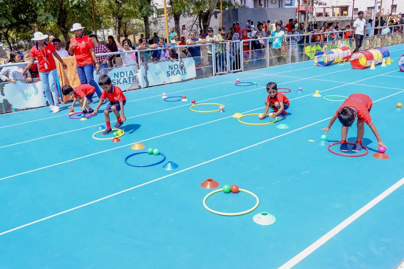 A child collects balls in a hoop race