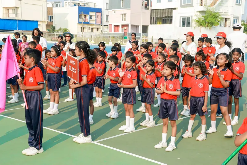 A class stands ready on the field in house colours