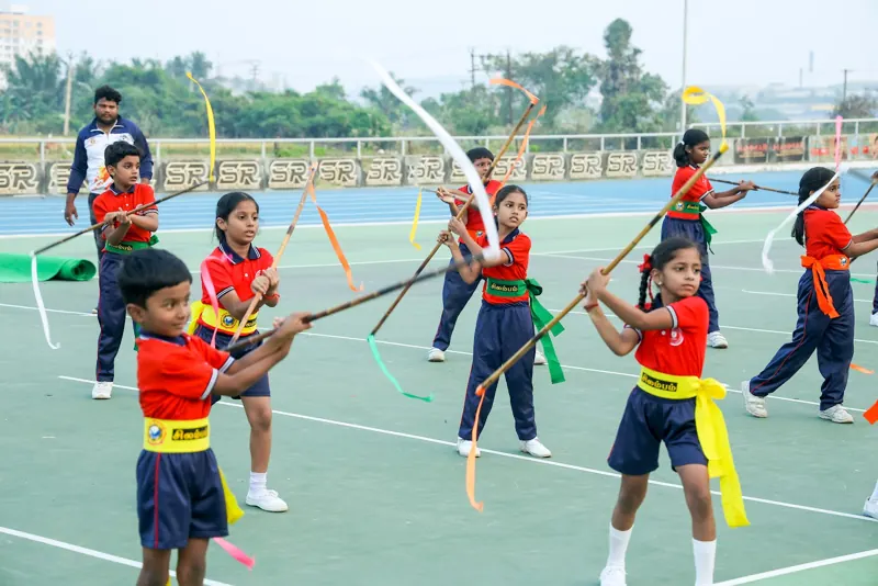 Children perform a ribbon drill