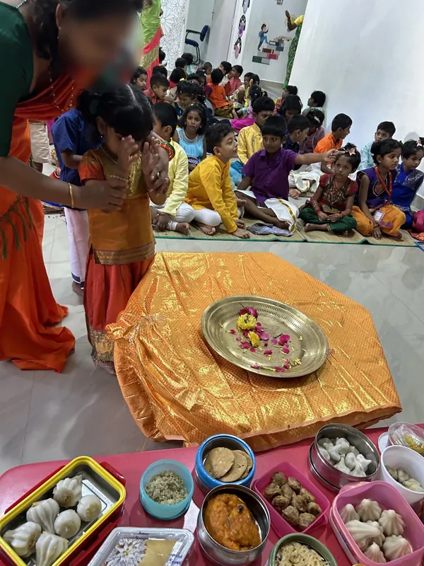 Children wait their turn to place flowers at the altar