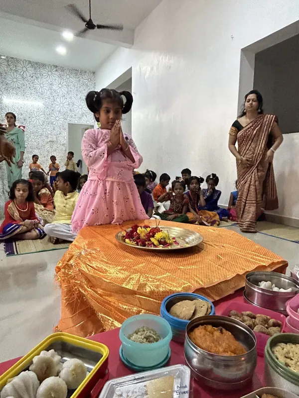 A child in festive dress waits at the altar
