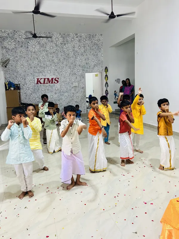 Children in festive clothes dance together